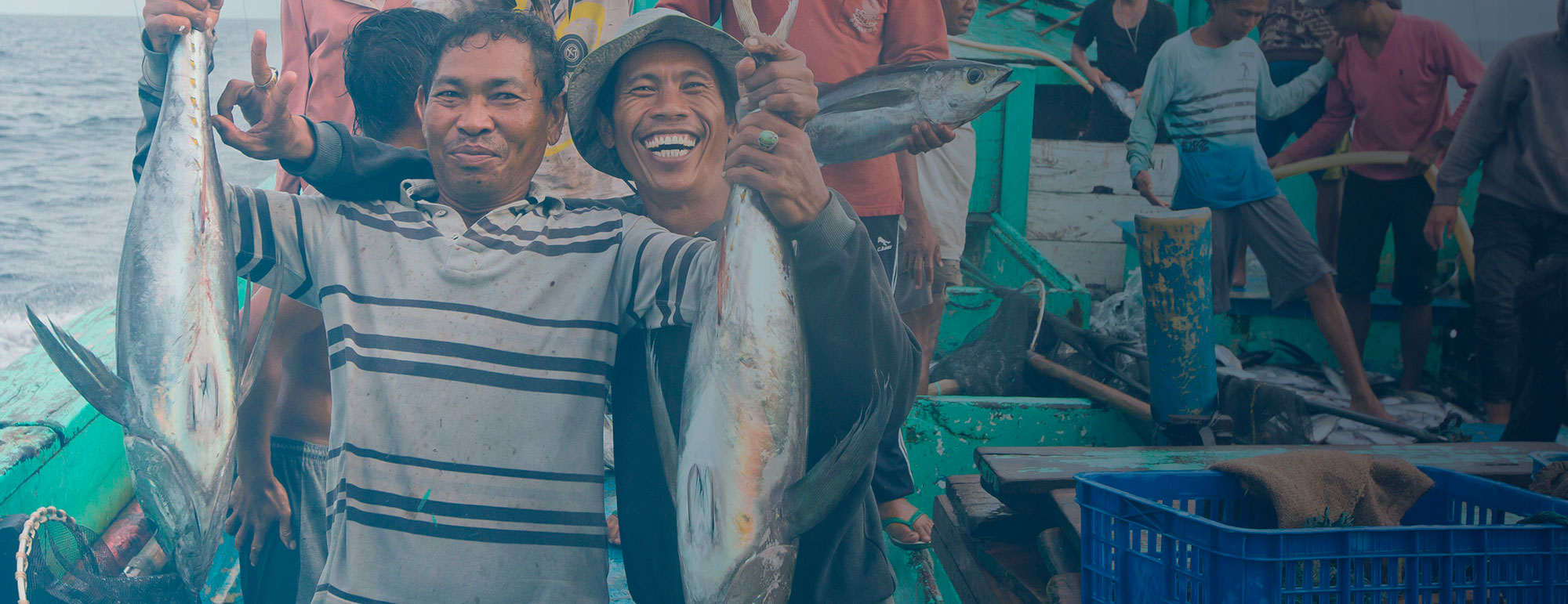 People with their fish caught by rod and line