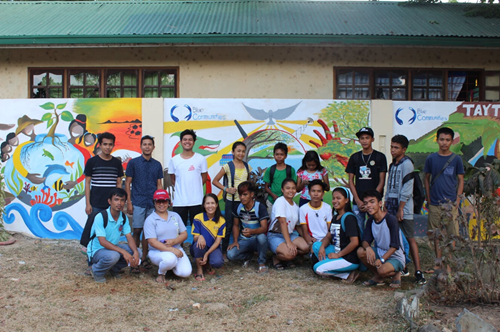 Young artists in front of their Blue Communities mural